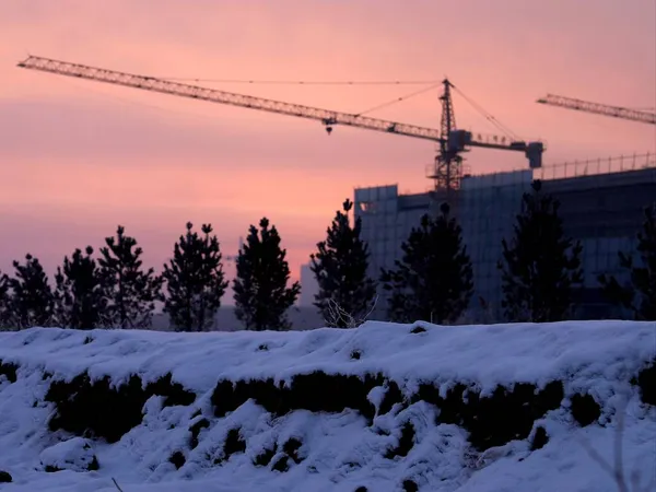 construction site with cranes and snow