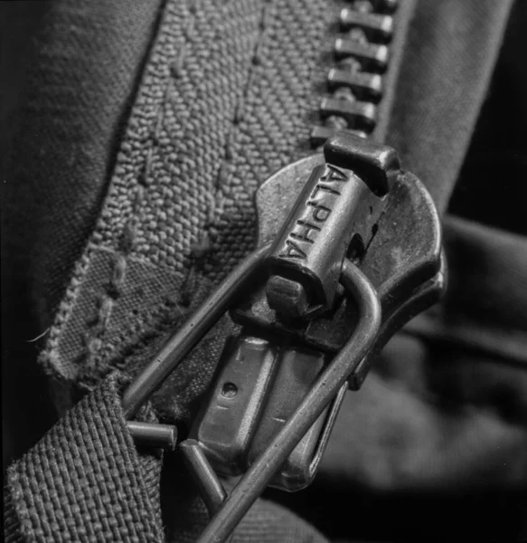close up of a black leather jacket with a chain