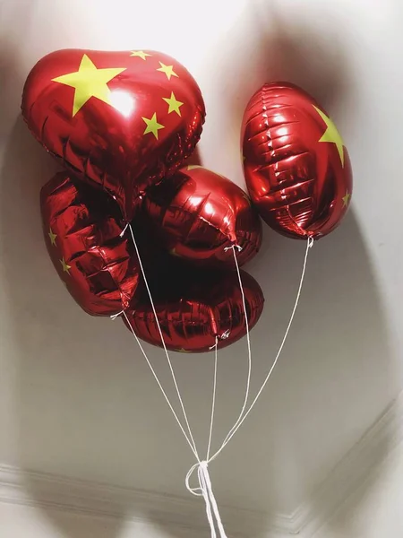red and white balloons on a black background