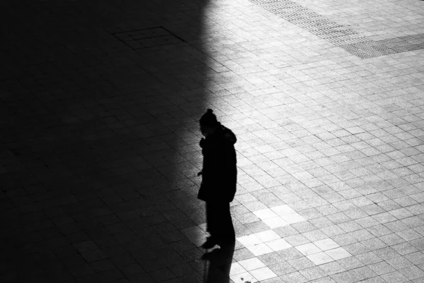 silhouette of a man walking on the street