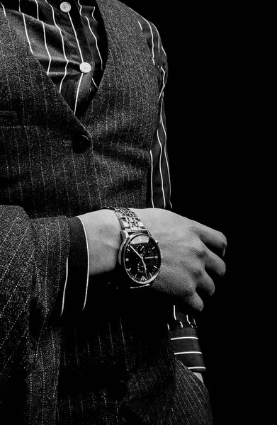 man with a watch on a black background