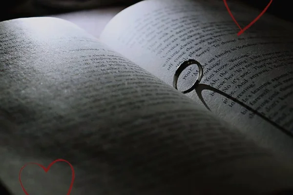 a book with a heart on a black background