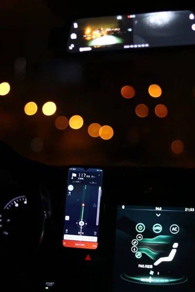 car dashboard with lights and mobile phone