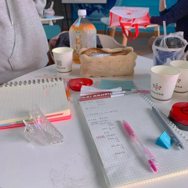 a closeup shot of a medical table with a pencil and a cup of coffee