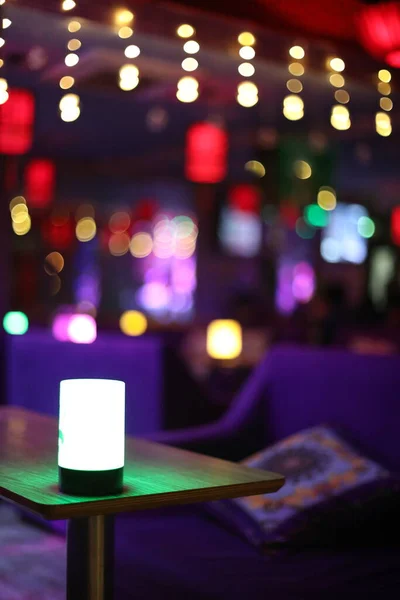 blurred background of a restaurant table with bokeh lights