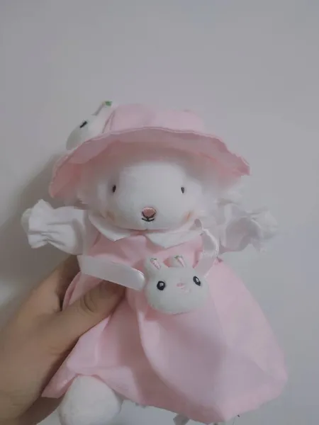 teddy bear with pink bow on a white background