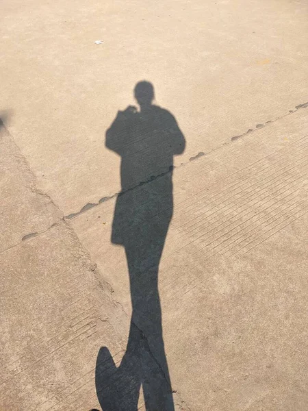 silhouette of a man walking on the street