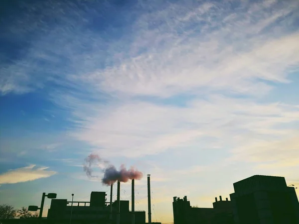 industrial factory, smoke and chimney, view from the window