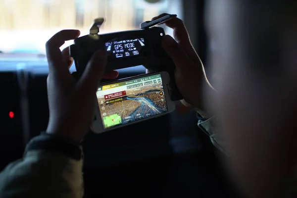 man playing video game on the screen of the car