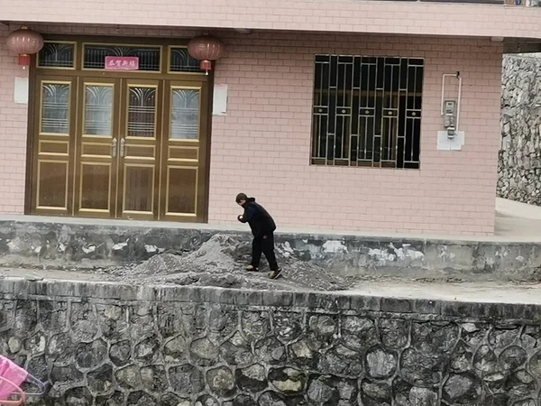 a man in a black jacket with a dog