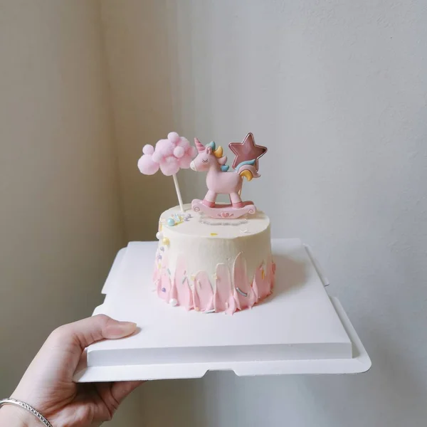 a vertical shot of a beautiful decorated birthday cake with a white background