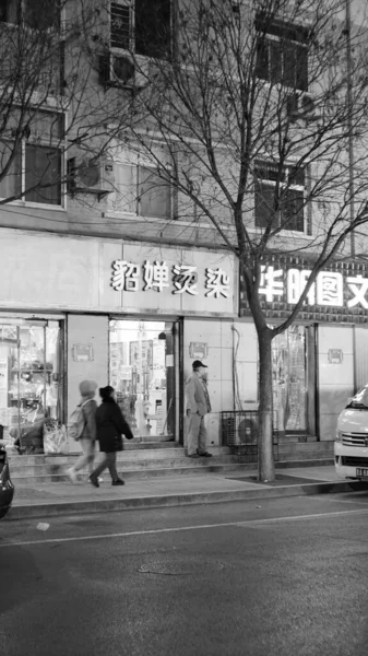 black and white photo of a street in the city