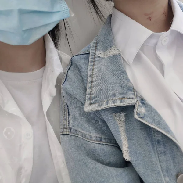 young couple in a white shirt and a blue jacket on a gray background