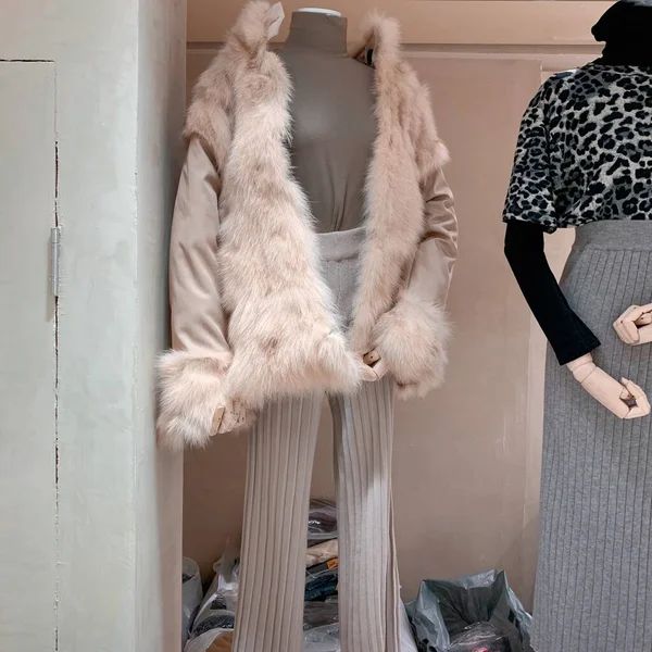 fashion mannequin in a fur coat and scarf