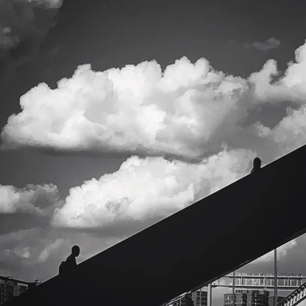 silhouette of a man and woman in the sky