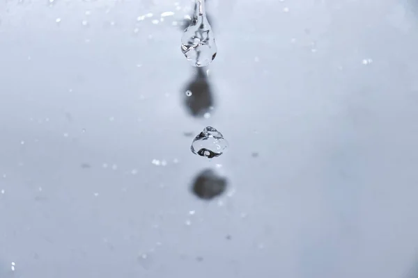 water drops on a glass with bubbles on a white background