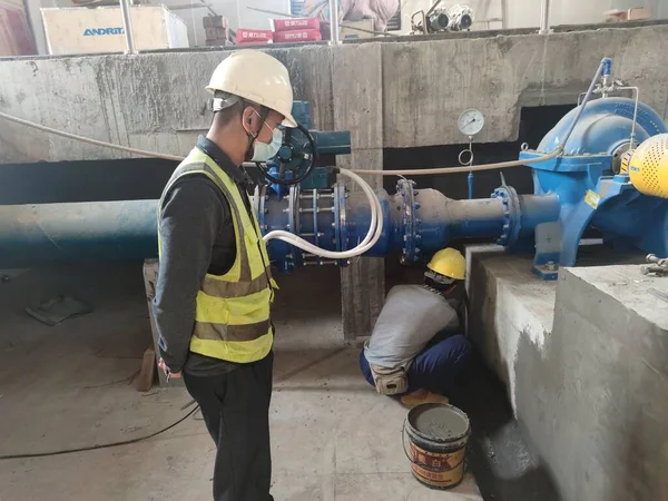 worker in protective helmet and gloves working on the construction site