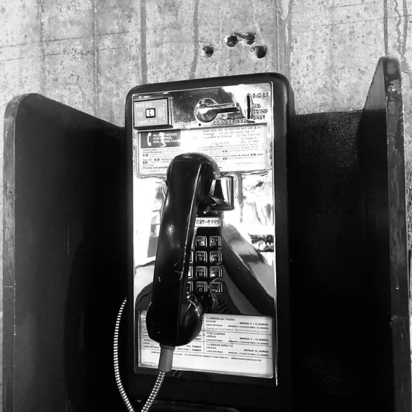 black and white telephone on the street