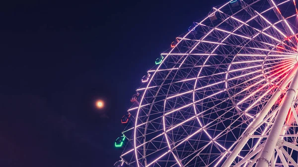 ferris wheel in amusement park, london, uk