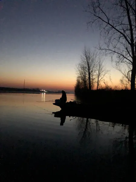 silhouette of a man in a lake