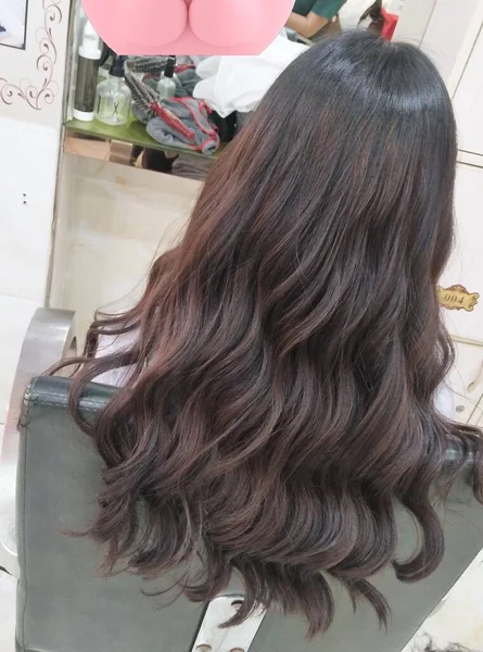 woman hairdresser with hair dryer in the shop