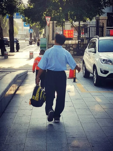 man in a suit walking on the street