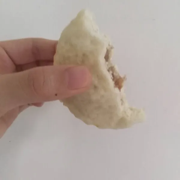 hand holding a white sponge on a light background