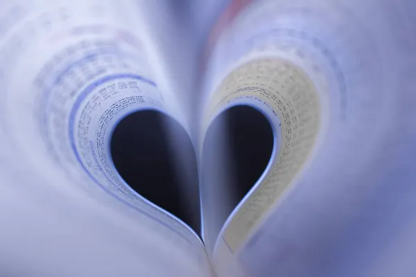 open book with a heart on a white background