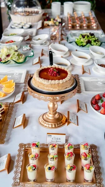 catering table with various dishes and sweets