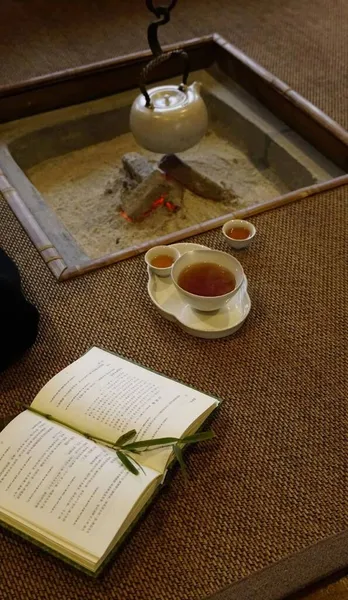 a cup of tea and a book on the table