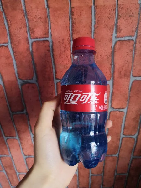 water bottle with red liquid in the background