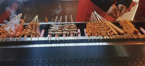 cooking sausages in the market