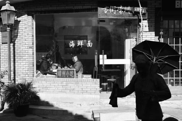 black and white photo of a young man in the city