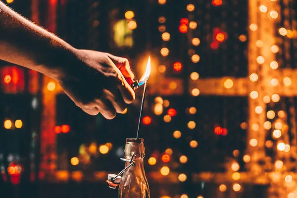 hand holding a candle in the hands of a man