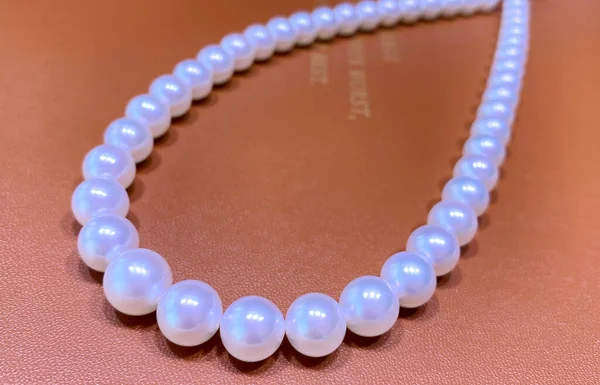 pearl necklace on a background of a beautiful red and white pearls