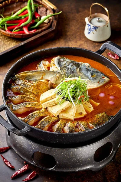 baked fish with vegetables and spices in a pan