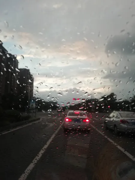 rainy weather, rain drops on the road