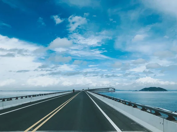 highway road with blue sky and clouds