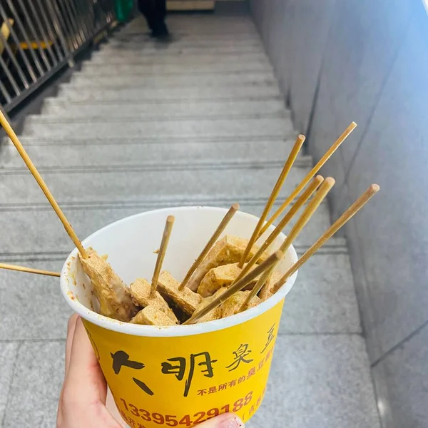 close up of a wooden sticks with a stick and a white plate