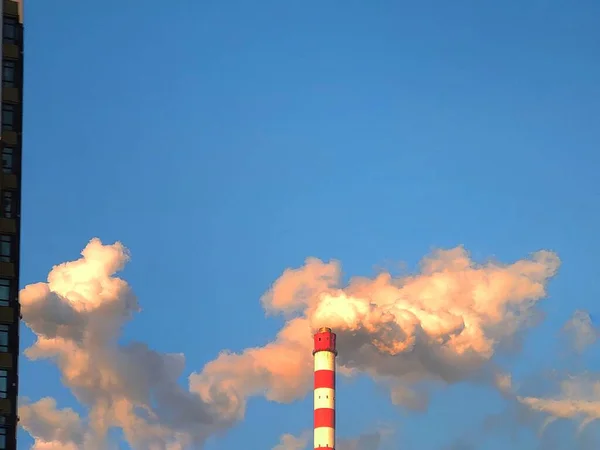 industrial chimney and smoke from the chimneys of the city