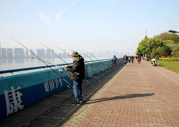 a man walks along the embankment of the river thames in the city of london