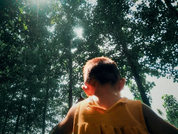 young man in a red shirt and a white t-shirts in the forest