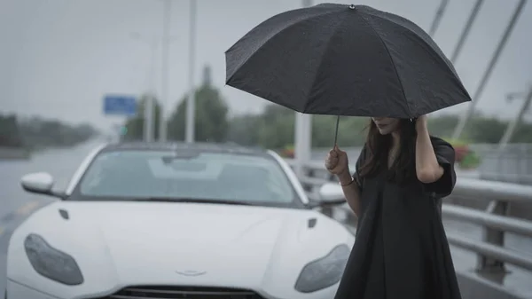 young woman with umbrella in the city