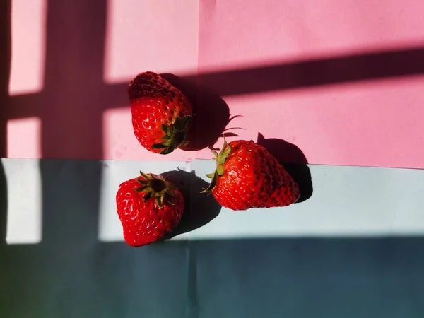 red and white strawberries on a black background