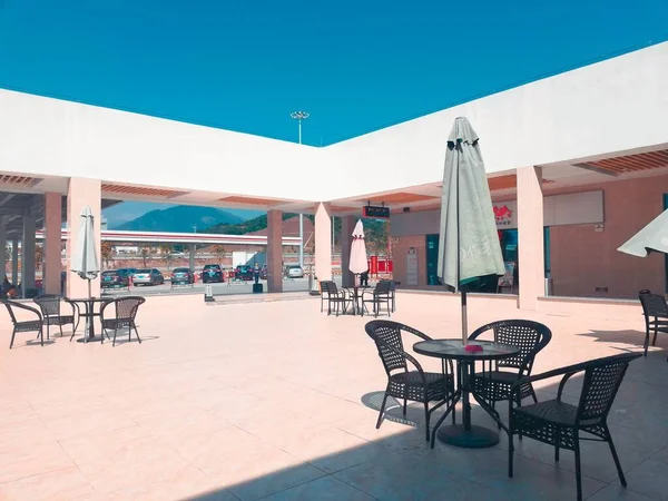 empty cafe with chairs and tables on the beach