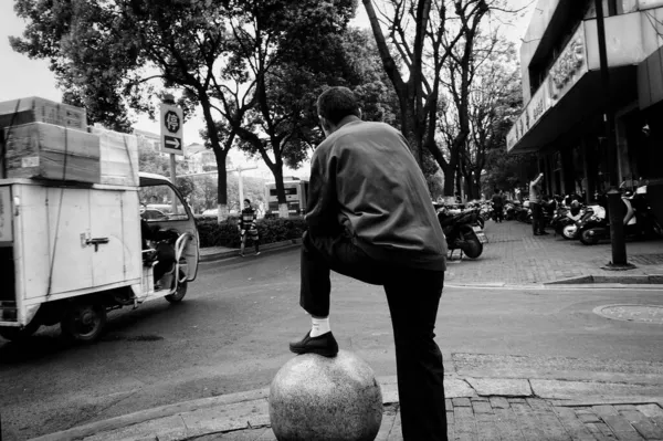 black and white photo of a man in the city