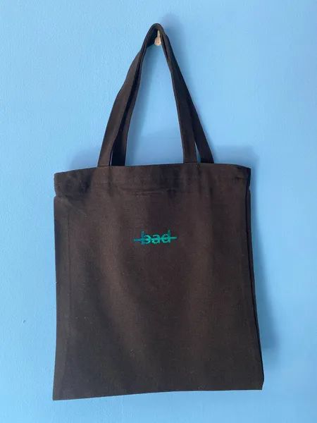 black bag with a paper shopping bags on a blue background