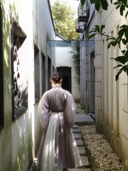 a man in a suit with a veil in the background of the old building