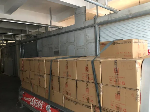 warehouse shelves with boxes and containers in the background