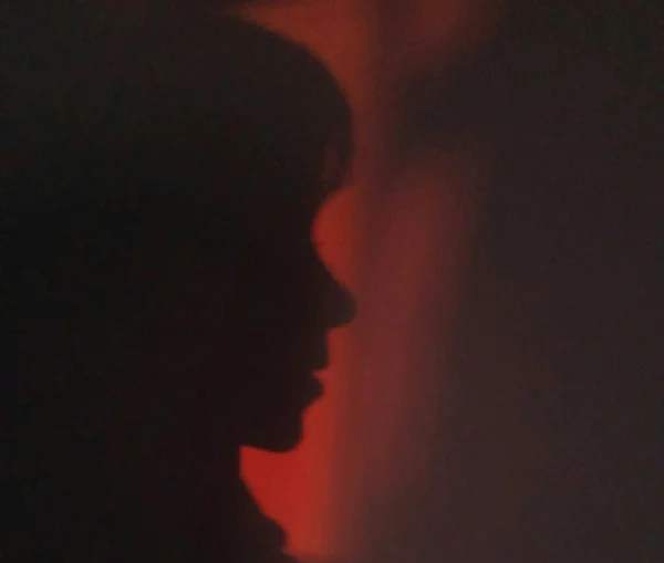 silhouette of a man with a red hair on a black background